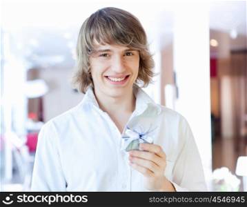 portrait of a young handsome man with a gift