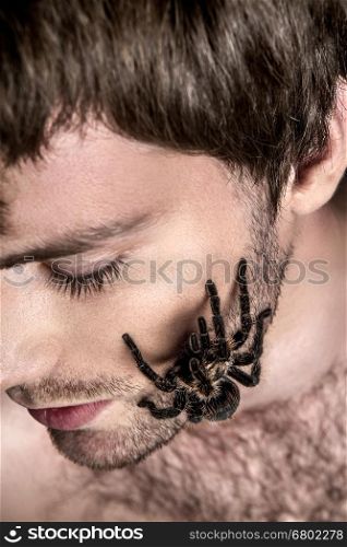 Portrait of a Young Handsome Man with Spider on His Face. Portrait of a Young Handsome Man with Big Spider on His Face