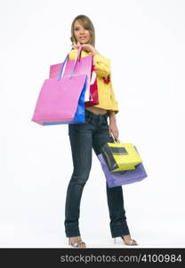 Portrait of a young happy woman with shopping bags