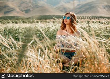 portrait of a young hippie girl on a wheat field
