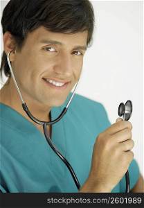 Portrait of a young male doctor wearing a stethoscope and smiling