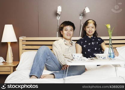 Portrait of a young man and a mid adult woman on the bed