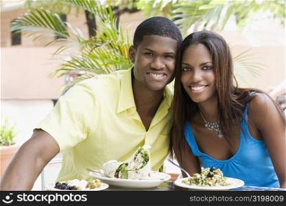 Portrait of a young man and a teenage girl sitting in a restaurant