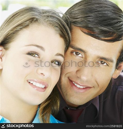 Portrait of a young man and a teenage girl smiling