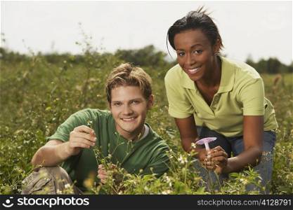 Portrait of a young man and a young woman in a field