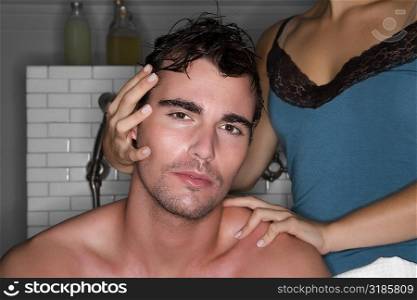 Portrait of a young man and his wife in the bathroom