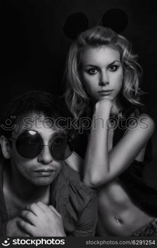 portrait of a young man and woman on a black background
