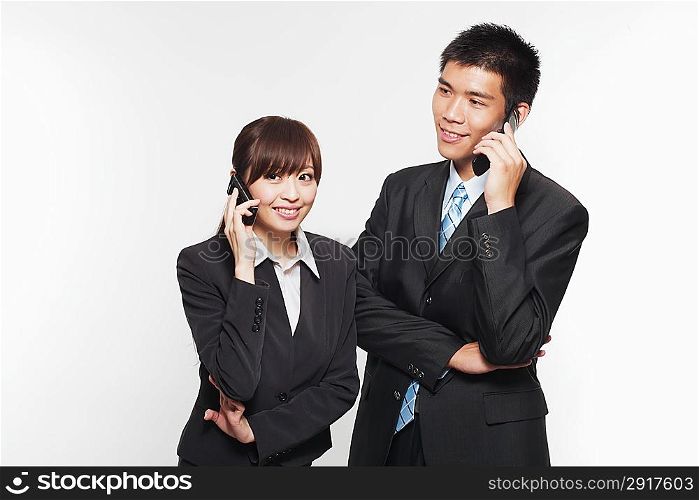 Portrait of a young man and woman telephoning