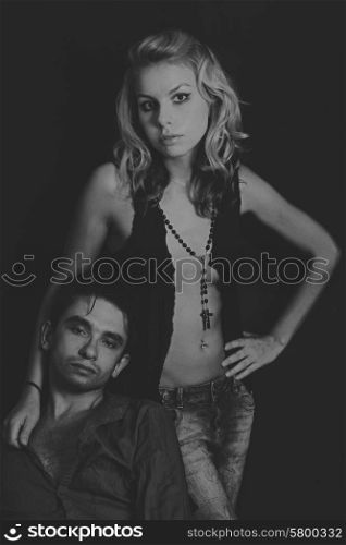 Portrait of a young man and women on a black background