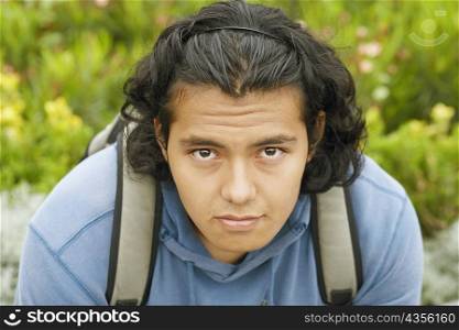 Portrait of a young man carrying a backpack