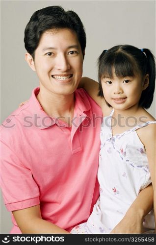 Portrait of a young man carrying his daughter