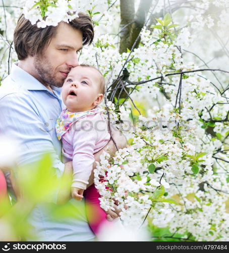 Portrait of a young man cuddling his daughter