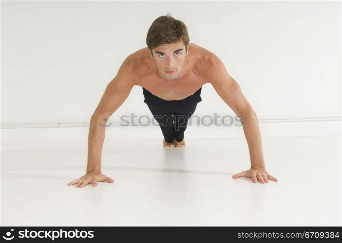 Portrait of a young man doing push-ups