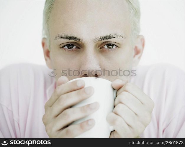Portrait of a young man drinking coffee from a cup