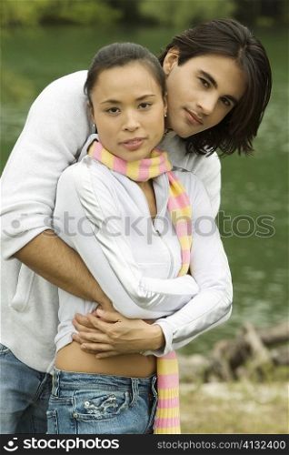 Portrait of a young man embracing a young woman