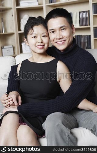 Portrait of a young man embracing a young woman smiling