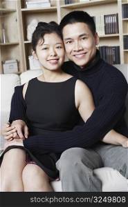 Portrait of a young man embracing a young woman smiling