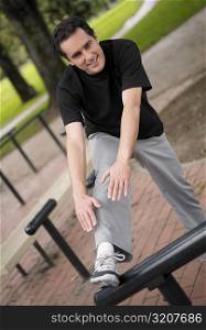 Portrait of a young man exercising in a park