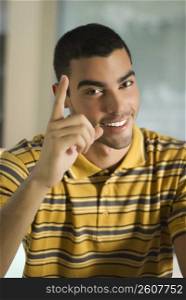 Portrait of a young man gesturing and smiling