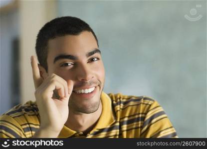 Portrait of a young man gesturing and smiling