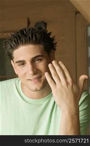 Portrait of a young man gesturing with his finger