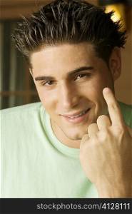 Portrait of a young man gesturing with his finger