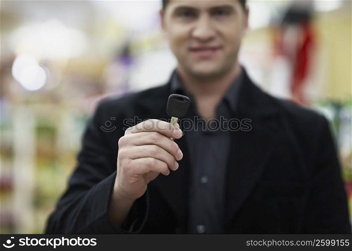 Portrait of a young man holding a car key