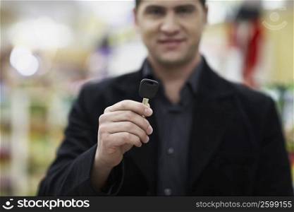 Portrait of a young man holding a car key