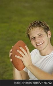 Portrait of a young man holding a rugby ball