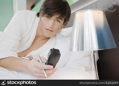 Portrait of a young man holding a telephone receiver