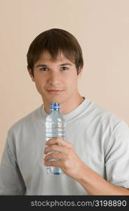 Portrait of a young man holding a water bottle