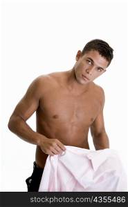 Portrait of a young man holding his shirt