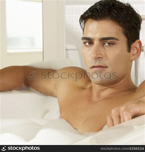 Portrait of a young man in a bathtub