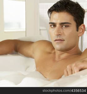 Portrait of a young man in a bathtub