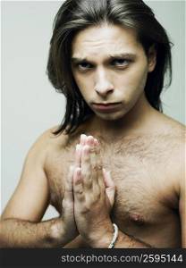 Portrait of a young man in a prayer position