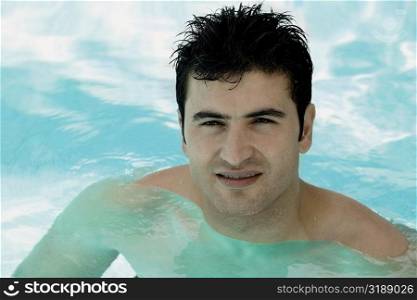 Portrait of a young man in a swimming pool