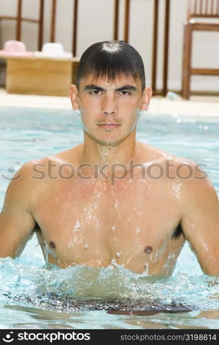 Portrait of a young man in a swimming pool