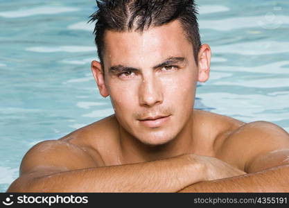 Portrait of a young man in a swimming pool