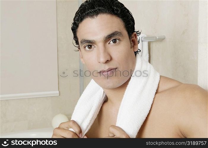 Portrait of a young man in the bathroom
