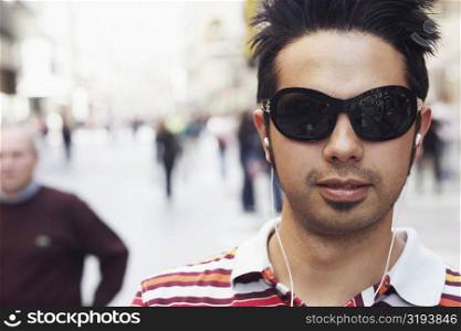 Portrait of a young man listening to an MP3 Player