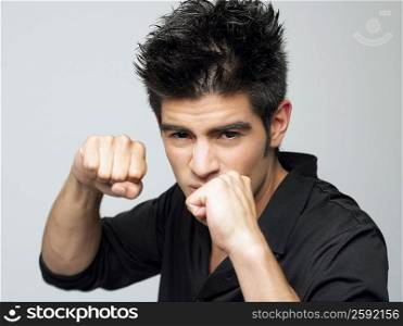 Portrait of a young man making a fist