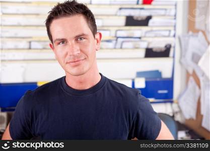 Portrait of a young man mechanic in office