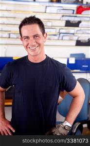 Portrait of a young man mechanic smiling, looking at the camera