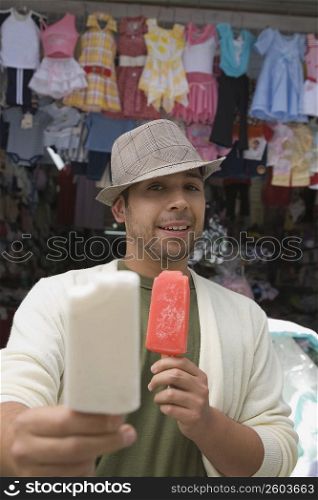 Portrait of a young man offering an ice cream