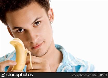 Portrait of a young man peeling a banana
