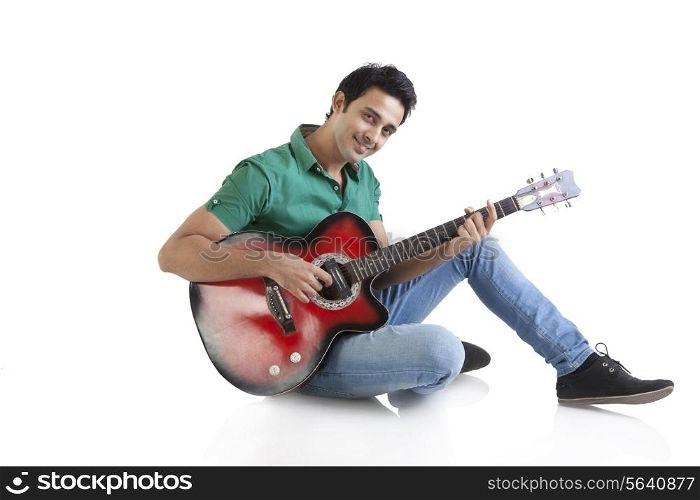 Portrait of a young man playing a guitar