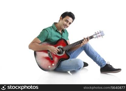 Portrait of a young man playing a guitar