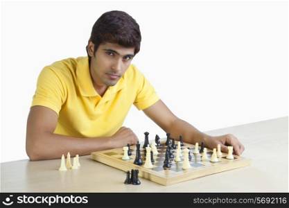 Portrait of a young man playing chess