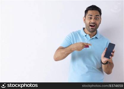 Portrait of a young man pointing at his Smartphone during online shopping