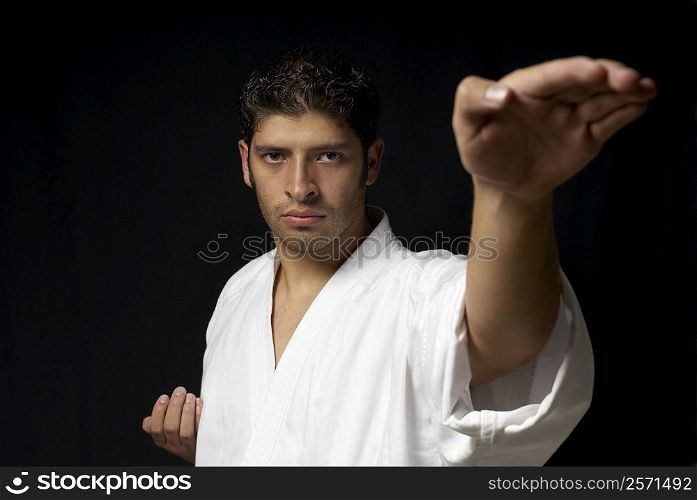 Portrait of a young man practicing karate